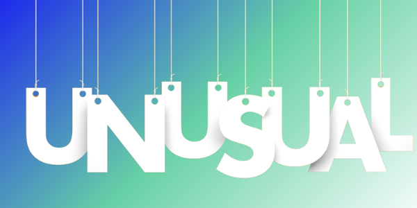 White letters spelling out the word unusual on a green and blue background.